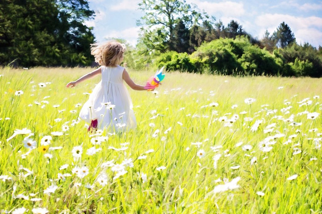little girl running, daisies, nature